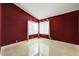 Spacious bedroom with dark red walls and tile floors at 18903 N 87Th Dr, Peoria, AZ 85382