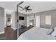 Main bedroom with a large TV, ensuite bathroom, and loft access at 19034 N 94Th Way, Scottsdale, AZ 85255