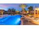 Inviting pool with a waterfall feature, surrounded by a patio and lounge chairs at 19034 N 94Th Way, Scottsdale, AZ 85255