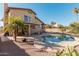 Two-story home with a kidney shaped pool and desert plants at 1918 E Hearn Rd, Phoenix, AZ 85022