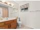 Bathroom with single vanity, toilet, and window coverings at 1918 E Hearn Rd, Phoenix, AZ 85022