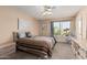 Spacious bedroom with a ceiling fan and large window offering natural light at 1918 E Hearn Rd, Phoenix, AZ 85022