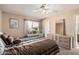 Bedroom with ceiling fan, large window, and striped bedding at 1918 E Hearn Rd, Phoenix, AZ 85022