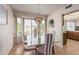 Dining room features a glass table, striped chairs, and a view of the backyard at 1918 E Hearn Rd, Phoenix, AZ 85022