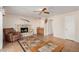 Gathering room with a stone fireplace, ceiling fan, and adjacent wet bar at 1918 E Hearn Rd, Phoenix, AZ 85022