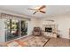 Gathering room with a stone fireplace, sliding doors, and a ceiling fan at 1918 E Hearn Rd, Phoenix, AZ 85022