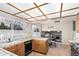 Kitchen with wood cabinets, tile countertops, and a built-in microwave at 1918 E Hearn Rd, Phoenix, AZ 85022