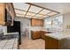 View of kitchen with wood cabinets, tile counters, and a breakfast bar at 1918 E Hearn Rd, Phoenix, AZ 85022