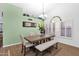 Formal dining area with a wood table, bench seating and window at 19222 N 70Th Ave, Glendale, AZ 85308