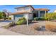 Two-story house with green garage door, landscaping, and basketball hoop at 19222 N 70Th Ave, Glendale, AZ 85308