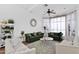 Living room with green velvet sofas, a coffee table and large windows at 19222 N 70Th Ave, Glendale, AZ 85308