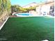 Inviting pool area featuring artificial turf and a patio at 19222 N 70Th Ave, Glendale, AZ 85308