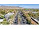 Aerial view of community with palm trees and mountains at 19961 W Heatherbrae Dr, Litchfield Park, AZ 85340