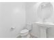 Simple bathroom with pedestal sink and toilet at 19961 W Heatherbrae Dr, Litchfield Park, AZ 85340