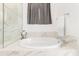 Relaxing bathroom with a large, free-standing soaking tub at 19961 W Heatherbrae Dr, Litchfield Park, AZ 85340