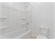 Clean bathroom with a shower/tub combo and built-in shelving at 19961 W Heatherbrae Dr, Litchfield Park, AZ 85340