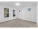 Bright bedroom with neutral carpeting and large windows at 19961 W Heatherbrae Dr, Litchfield Park, AZ 85340