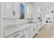 Kitchen with white cabinets, granite counters, and a view to Gathering room at 19961 W Heatherbrae Dr, Litchfield Park, AZ 85340