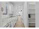 White kitchen cabinets, granite countertops and view of pantry at 19961 W Heatherbrae Dr, Litchfield Park, AZ 85340