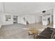 Open concept living room with a view of the kitchen and staircase at 19961 W Heatherbrae Dr, Litchfield Park, AZ 85340