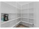 Walk-in pantry with ample shelving for storage at 19961 W Heatherbrae Dr, Litchfield Park, AZ 85340