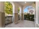 Covered porch with arched entryway and wrought iron railings at 19961 W Heatherbrae Dr, Litchfield Park, AZ 85340