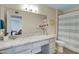 Bathroom featuring a white granite vanity, mirror, and a shower with patterned curtain at 2059 E Brown Rd # 23, Mesa, AZ 85213