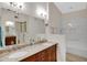 Bathroom featuring double vanity with granite countertop and shower over tub at 2059 E Brown Rd # 23, Mesa, AZ 85213