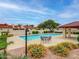 Community pool with table and chairs, trees, and covered seating area at 2059 E Brown Rd # 23, Mesa, AZ 85213