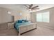 Main bedroom with ceiling fan and large window at 2071 E Piedmont Pl, Casa Grande, AZ 85122