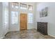 Bright entryway with tiled floors and wood front door at 2265 E Mallard Ct, Gilbert, AZ 85234