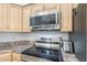 Close up of kitchen with stainless steel stove and microwave at 2265 E Mallard Ct, Gilbert, AZ 85234