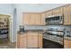 Kitchen corner with stainless steel appliances and wood cabinets at 2265 E Mallard Ct, Gilbert, AZ 85234