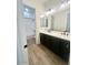 Bathroom with double vanity, dark cabinets, and a shower/tub combo at 22910 E Alyssa Rd, Queen Creek, AZ 85142