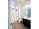 Modern bathroom with white bathtub and dark vanity at 22910 E Alyssa Rd, Queen Creek, AZ 85142