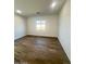 Bright bedroom with wood-look floors and large window at 22910 E Alyssa Rd, Queen Creek, AZ 85142