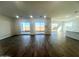 Large living room with wood-look floors and multiple windows at 22910 E Alyssa Rd, Queen Creek, AZ 85142