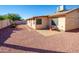 Sunny backyard with gravel, patio, and decorative tree at 2613 E Michigan Ave, Phoenix, AZ 85032