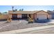 Single-story house with a two-car garage and well-maintained landscaping at 2613 E Michigan Ave, Phoenix, AZ 85032