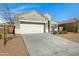 Modern home with gray exterior, two-car garage, and desert landscaping at 29402 W Mitchell Ave, Buckeye, AZ 85396