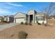 Newly built home with gray exterior, two-car garage, and drought-tolerant landscaping at 29402 W Mitchell Ave, Buckeye, AZ 85396