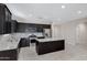 Modern kitchen with dark wood cabinets, granite island, and stainless steel appliances at 29402 W Mitchell Ave, Buckeye, AZ 85396