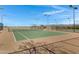 Two lighted tennis courts with surrounding fence at 29402 W Mitchell Ave, Buckeye, AZ 85396