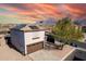 Two-story house with solar panels and a brown garage door, mountain views in the background at 3234 S Bowman Rd, Apache Junction, AZ 85119