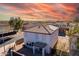 Aerial view of a house with solar panels and a beautiful sunset in the background at 3234 S Bowman Rd, Apache Junction, AZ 85119