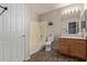 Bathroom with wood vanity, toilet, and vinyl flooring at 3234 S Bowman Rd, Apache Junction, AZ 85119