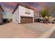 Two-story house with a brown garage door and driveway, desert landscape in the background at 3234 S Bowman Rd, Apache Junction, AZ 85119