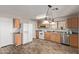 Kitchen features wood cabinets, stainless steel appliances, and vinyl flooring at 3234 S Bowman Rd, Apache Junction, AZ 85119