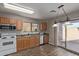 View of kitchen with wood cabinets, stainless steel appliances, and vinyl flooring at 3234 S Bowman Rd, Apache Junction, AZ 85119