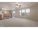 Open living room and kitchen area with carpeted floor and kitchen island at 3234 S Bowman Rd, Apache Junction, AZ 85119